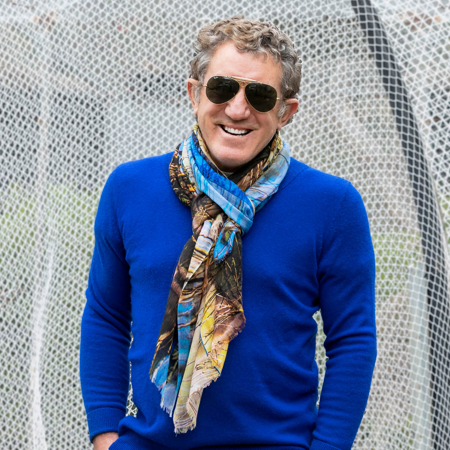 man in blue jumper wearing the dam wool cashmere scarf