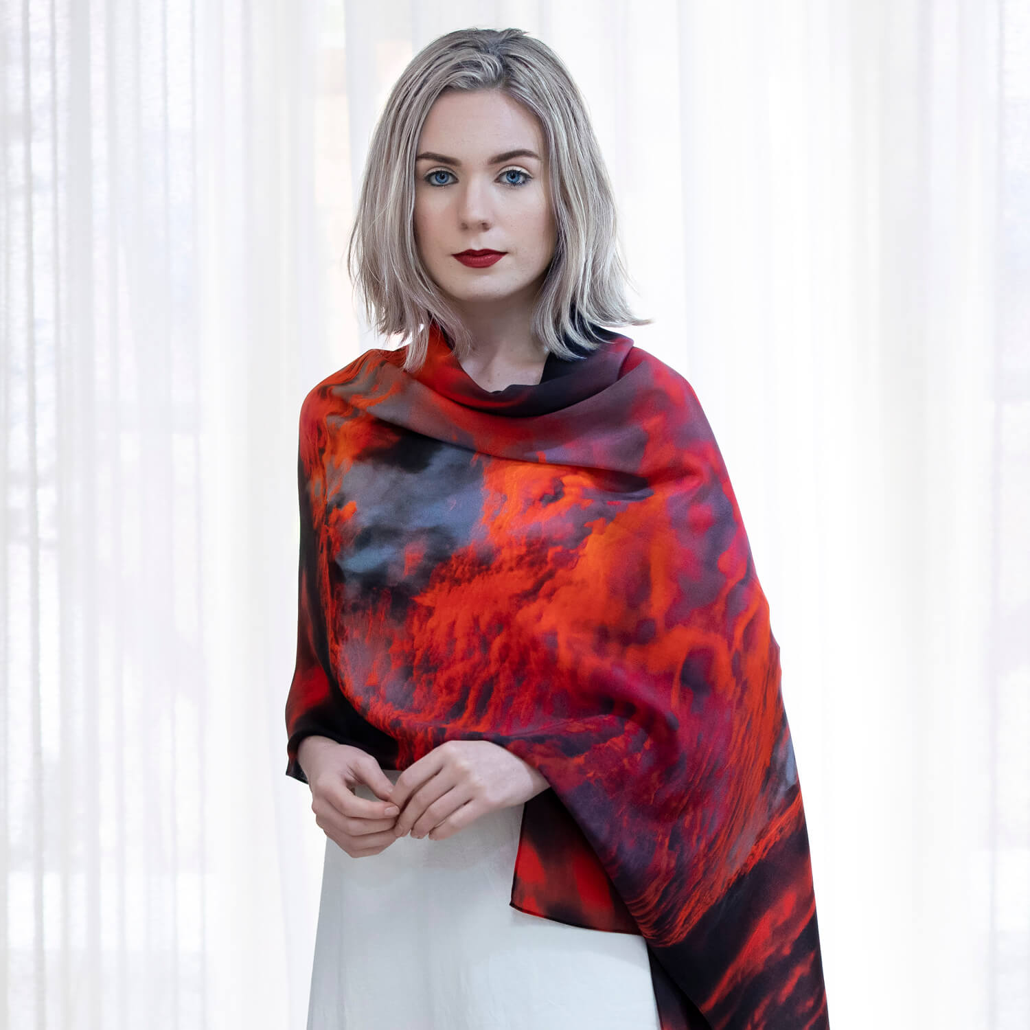 lady weasring red hot silk scarf as shawl over white dress