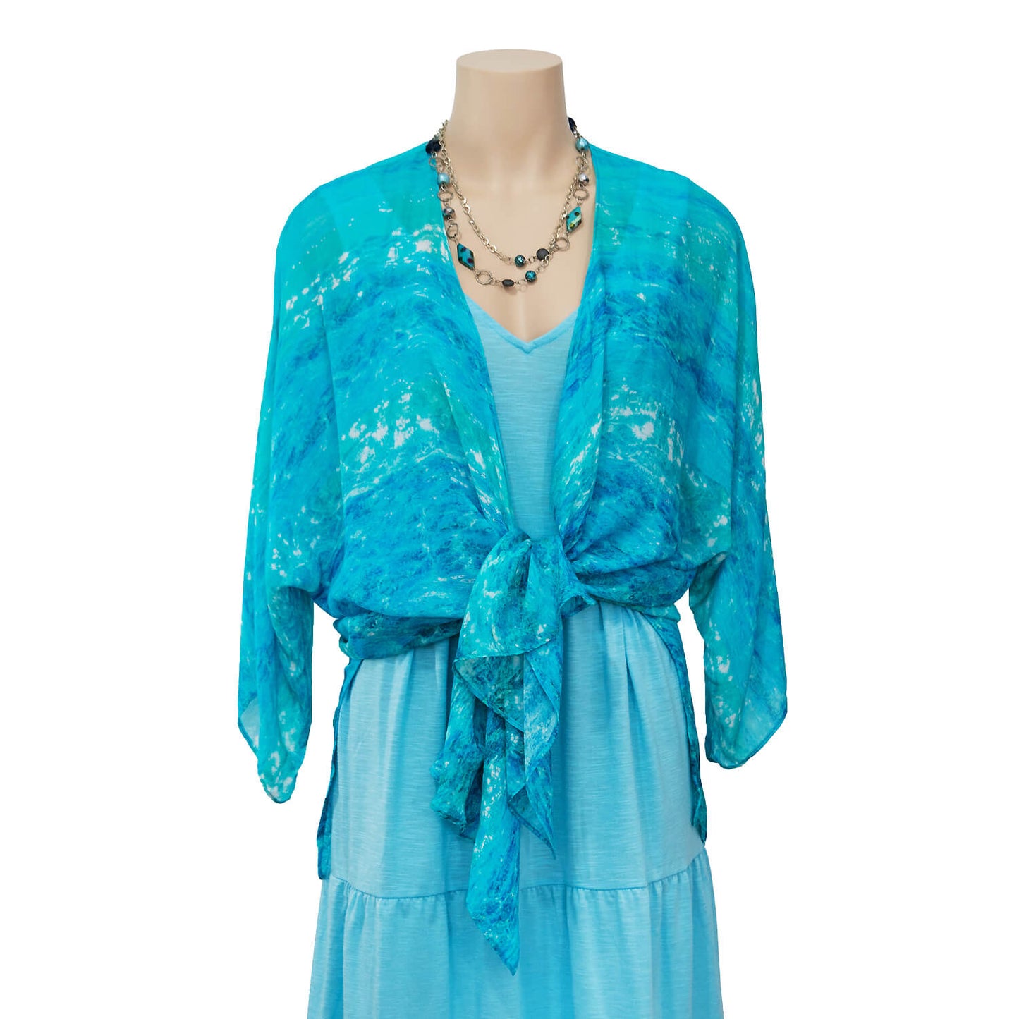 turquoise bay waterfall jacket tied in front over blue dress by seahorse silks
