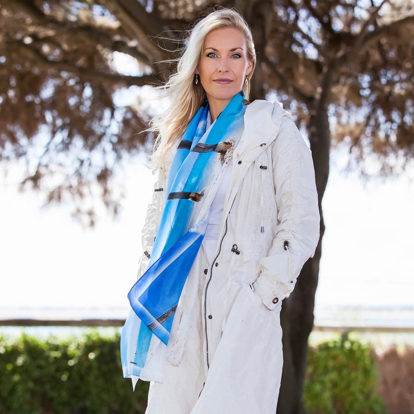blue poles silk scarf with white coat by seahorse silks
