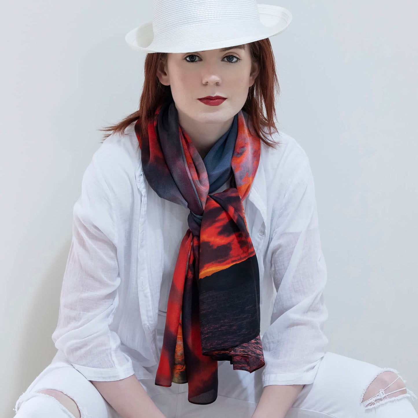 lady in white wearing red hot silk scarf by seahorse silks